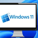 Ein Monitor zeigt das Windows 11 Logo, bereit für das Einrichten des neuen PCs.