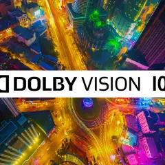 Bunte Stadt bei Nacht, beleuchtet von Straßenlaternen und Gebäuden. Das Logo "Dolby Vision IQ" überlagert die Szene und verspricht ein immersives Seherlebnis.