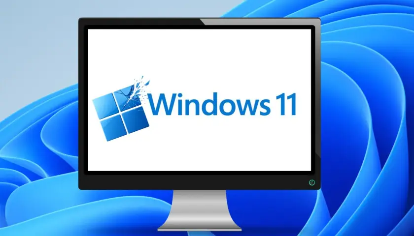 Ein Monitor zeigt das Windows 11 Logo, bereit für das Einrichten des neuen PCs.
