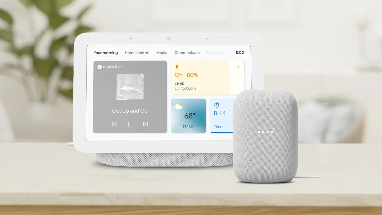 Google Nest Hub 3 mit Musik und Wetteranzeige, daneben ein Google Nest Mini.