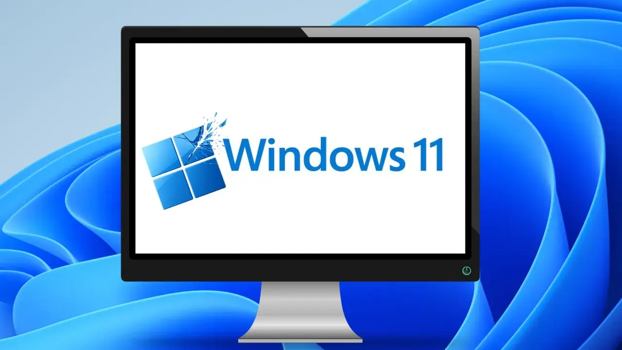 Ein Monitor zeigt das Windows 11 Logo, bereit für das Einrichten des neuen PCs.