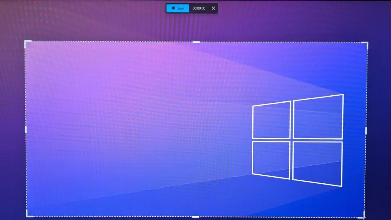 Bildschirmaufnahme von Windows 11 mit dem Start-Button und Timer. Das Fenster ist mit gestrichelten Linien markiert.